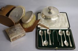 A silver cigarette box, cased set of spoons, cased pair of clothes brushes and a silver mounted