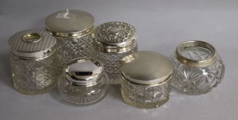 Six assorted silver mounted toilet jars.