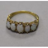 A 9ct gold and graduated five stone white opal ring, size T.