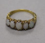 A 9ct gold and graduated five stone white opal ring, size T.