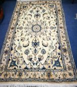 A Nain cream rug 205cm. x 115cm.