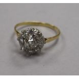 A mid 20th century 18ct gold and diamond cluster ring, size O.