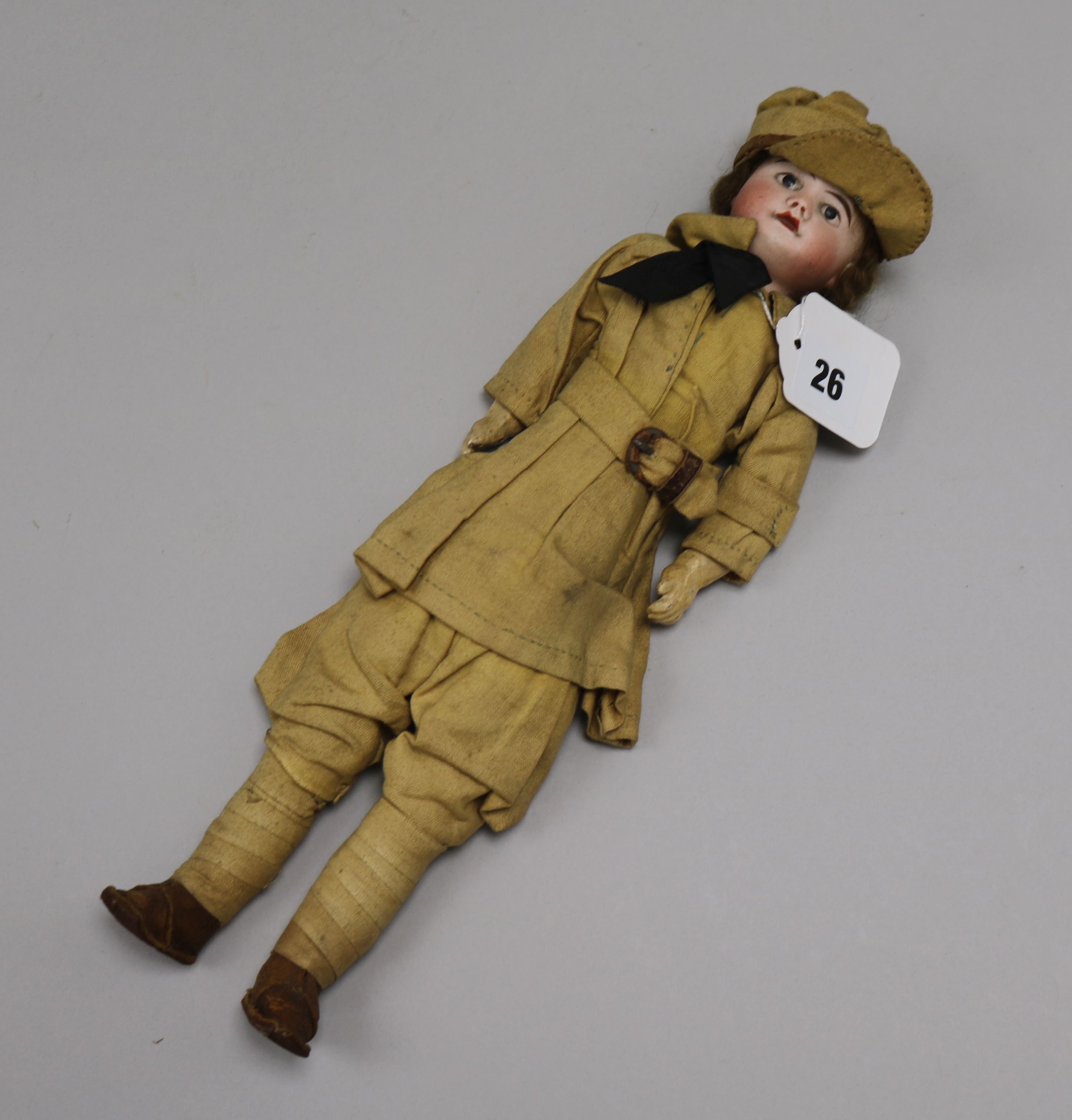 A French bisque head doll dressed in WWI army uniform length 33cm