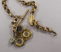 A 9ct gold fancy link albert hung with four assorted charms including three compasses.