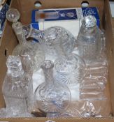 A collection of cut glass and pressed glass decanters