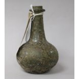 A Roman green glass bottle, of globular form with long narrow neck and iridescent overlay (rim a.