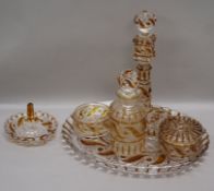 A Baccarat five piece clear and amber glass dressing table set