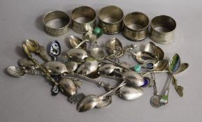 A collection of silver and silver plated souvenir and other spoons and five silver napkin rings,
