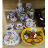 A collection of Poole Pottery, including thirteen items decorated with flowers and birds, comprising
