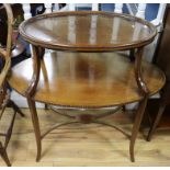 An Edwardian inlaid mahogany oval étagère W.90cm.