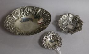 Two pierced silver bonbon dishes and a larger silver dish.