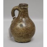 A small tiger ware jug, probably 17th century, of typical bulbous form with loop handle, H 14cm