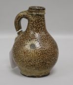 A small tiger ware jug, probably 17th century, of typical bulbous form with loop handle, H 14cm