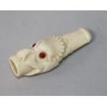 A late Victorian / Edwardian ivory cheroot holder carved as a grotesque fish head with inset eyes,