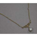 An early 20th century 18ct gold and cultured? pearl drop necklace, the chain set with seed pearls,