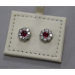 A pair of 18ct ruby and diamond cluster flower head earrings, 8mm.