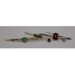 An early 20th century yellow metal, seed pearl and emerald bar brooch, a 15ct? gold bar brooch and