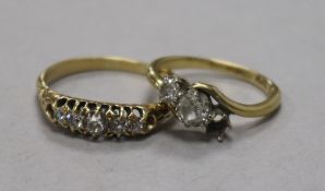 An 18ct gold and graduated five stone diamond ring and an 18ct gold and two (ex 3) stone diamond