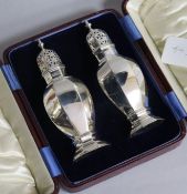 A cased pair of Edwardian silver sugar casters by Martin, Hall & Co, Sheffield, 1906, 16cm, 7 oz.