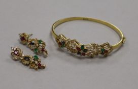 An 18ct gold, diamond and gem set hinged bracelet and a pair of matching earrings.