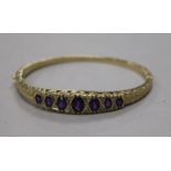 A Victorian style 9ct gold, amethyst and diamond set hinged bracelet.