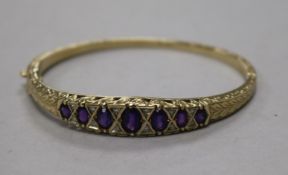 A Victorian style 9ct gold, amethyst and diamond set hinged bracelet.