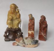 Four Chinese soapstone carvings, including a figure of an Immortal on pierced plinth base, two seals