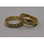 An 18ct gold and gypsy set three stone diamond ring and one other 18ct gold and diamond ring.