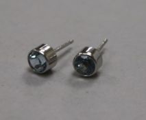 A pair of 18ct white gold and solitaire aquamarine ear studs.