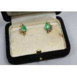 A pair of 14ct gold and jadeite earrings.