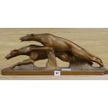 A plaster figure of Greyhounds, signed width 59cm height 23cm