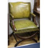 A pair of leather x-frame armchairs W.64cm