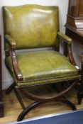 A pair of leather x-frame armchairs W.64cm