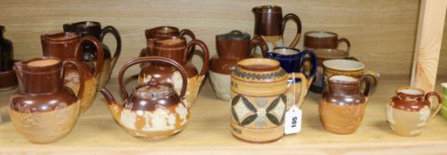 A collection of Doulton and other stoneware jugs and vessels