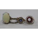 Three 9ct gold gem set rings including white opal, together with a diamond eternity ring (1 stone