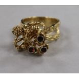 A 1970's? 14ct gold and garnet set rustic cocktail ring, size M.