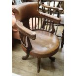 An Edwardian leather upholstered desk chair