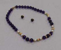An 18ct gold, amethyst and cultured pearl bead necklace and a pair of 9ct gold amethyst ear studs (