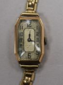 A lady's 1930's 9ct gold octagonal cased manual wind wrist watch, on a 9ct gold strap.