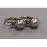 A pair of yellow metal, cultured pearl and diamond earrings.