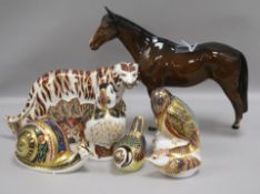 Six Royal Crown Derby paperweights and a Beswick bay horse, the paperweights to include a Bengal