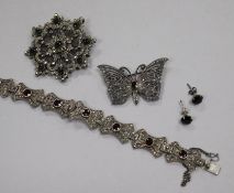 A silver marcasite and garnet set bracelet, two silver and marcasite brooches and a pair of