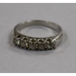 A white metal and five stone diamond ring, size M.