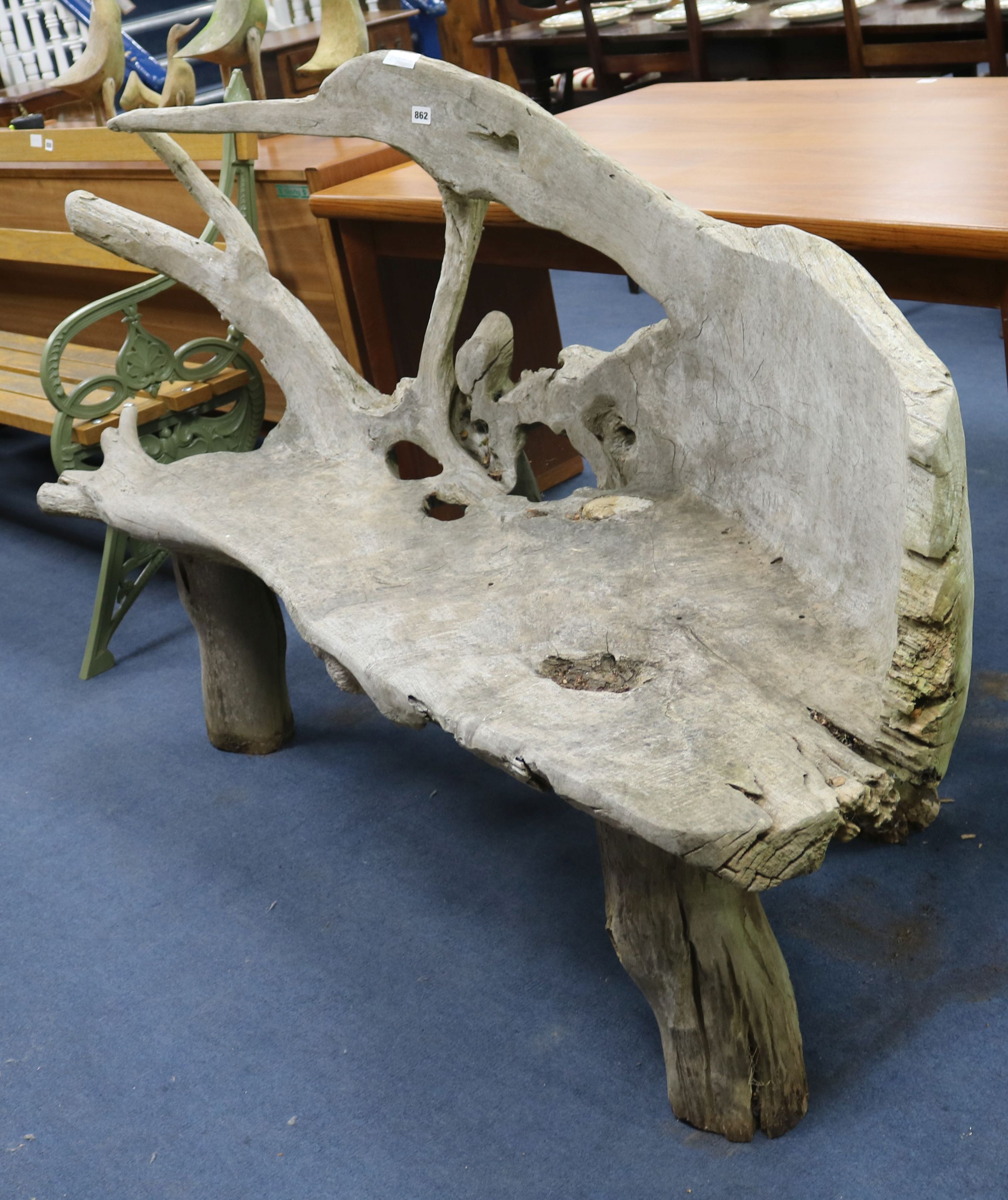 A teak sculptural bench W.175cm