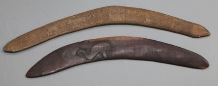 Two hardwood boomerangs, one carved with an emu, 55cm, the other a hunter and animals, 64cm