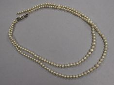 A double strand graduated cultured pearl necklace with cultured pearl set clasp (a.f.), 42cm.