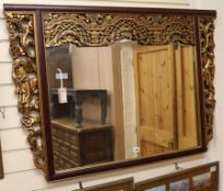 A Chinese carved and parcel-gilt wall mirror W.122cm