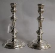 A pair of silver candlesticks with knopped stems, weighted, London 1972; Makers; William Comyns