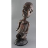 An African hardwood carving of a seated man, 52cm