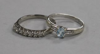 A platinum and diamond half hoop ring and a 9ct white gold, blue topaz and diamond ring.